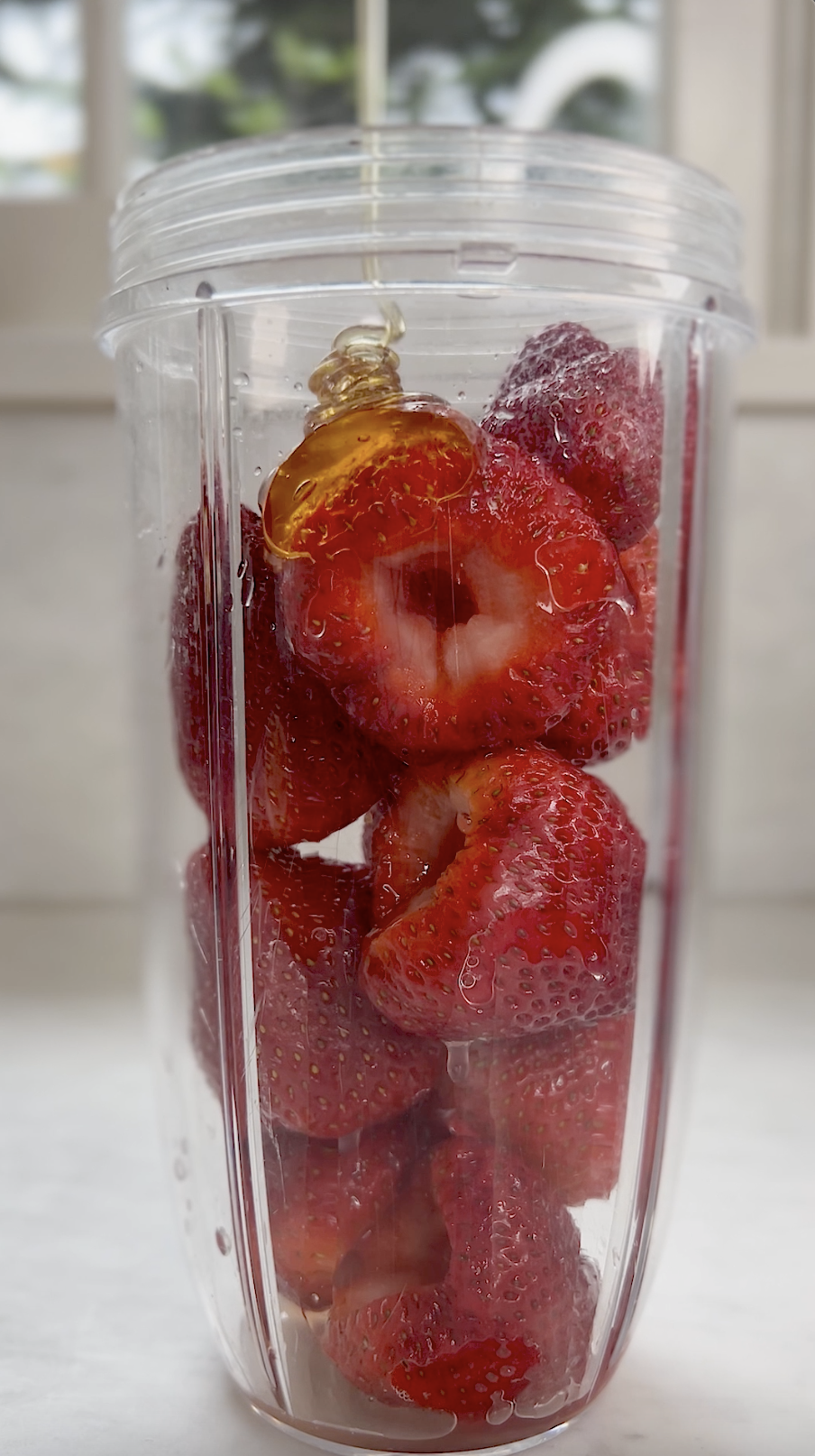Strawberries, lemon juice and honey in small blender.