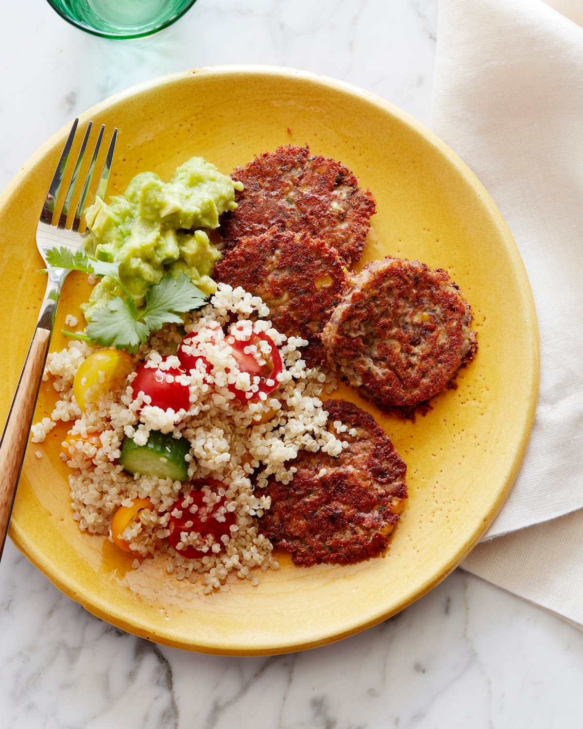 Black bean cakes on plate served with quinoa salad.