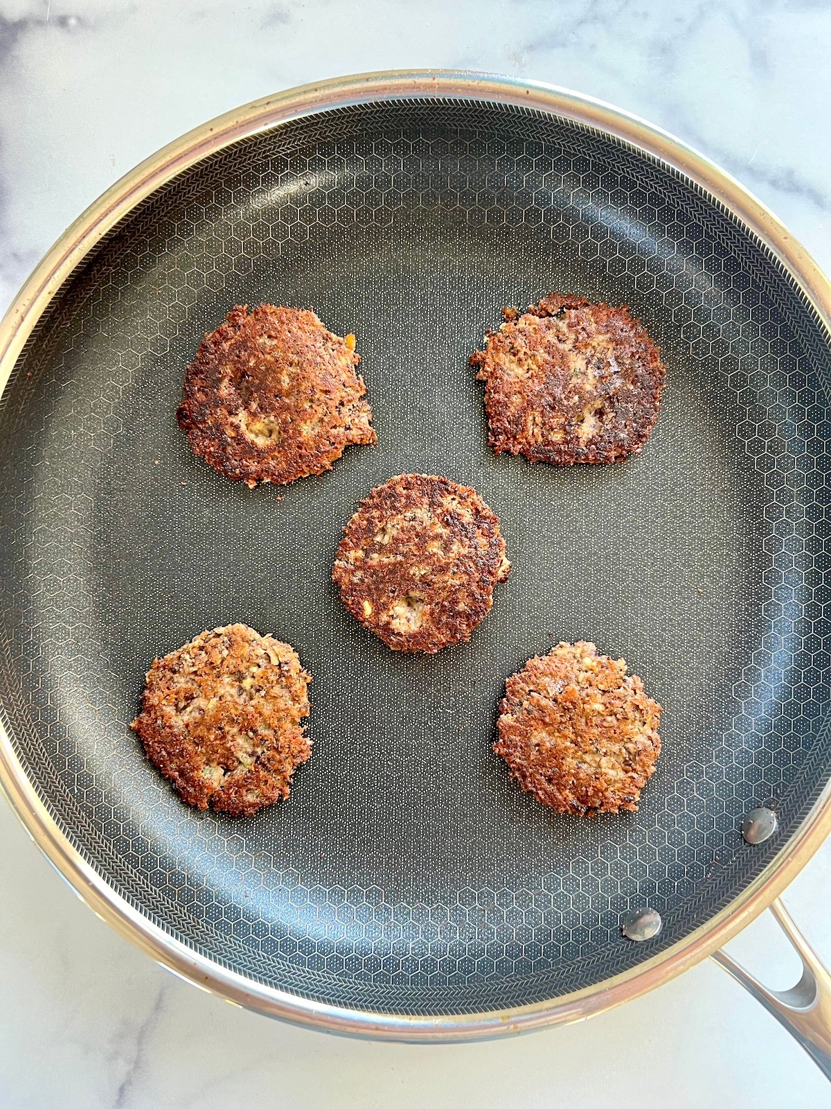 Black bean cakes in sauté pan.