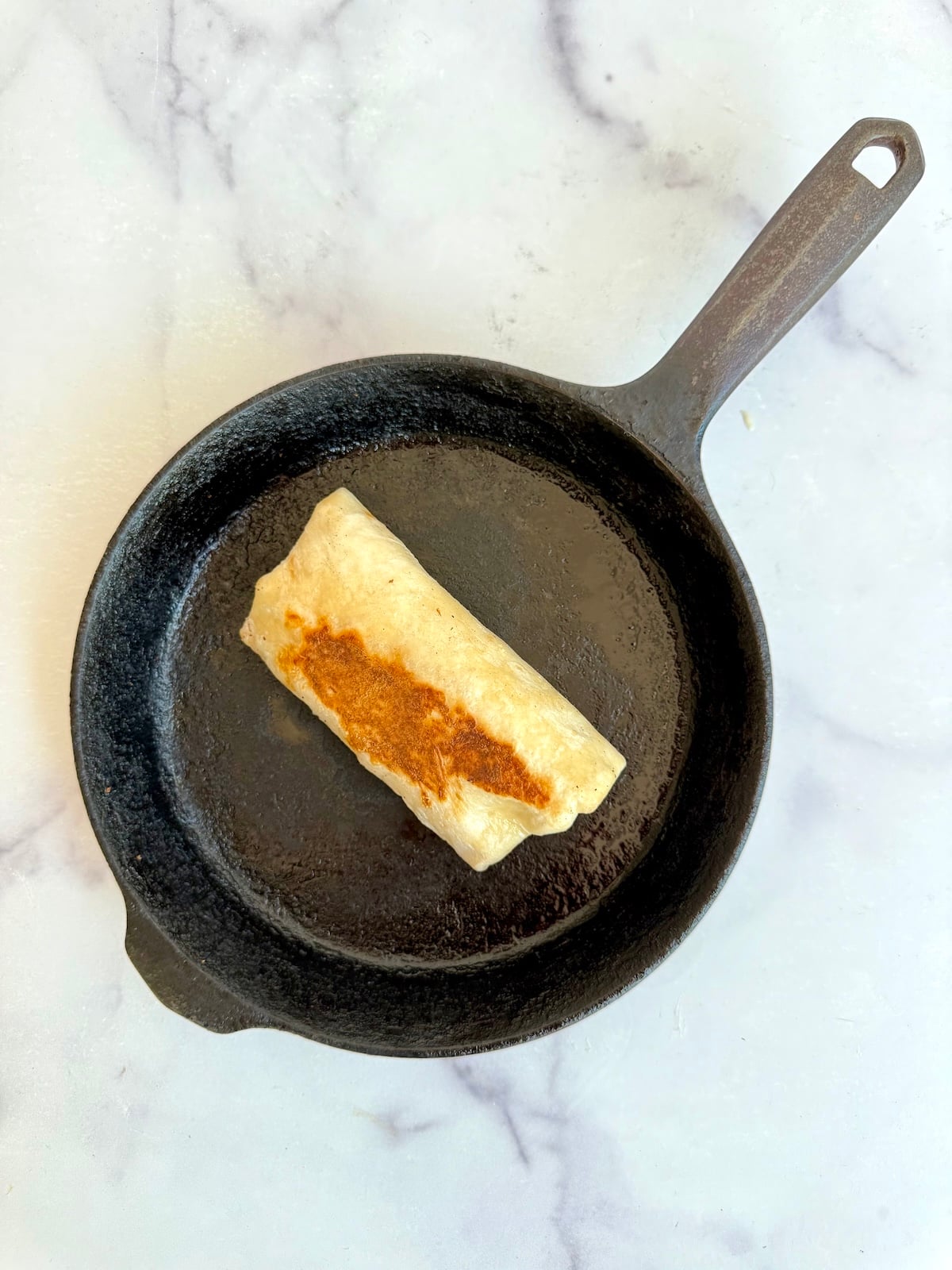 Breakfast burrito in a skillet.