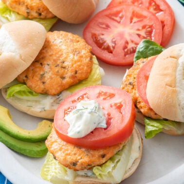 Salmon burgers on a plate.