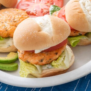 A salmon burger on a plate.