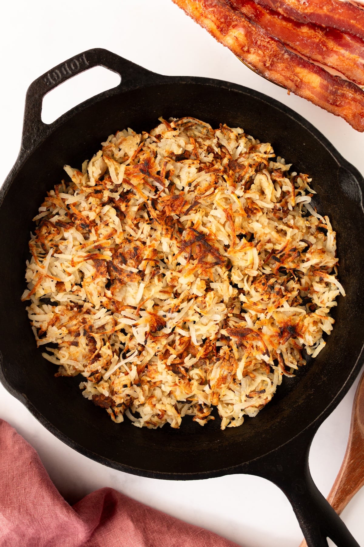 Crispy hash brown potatoes in a cast iron skilet.