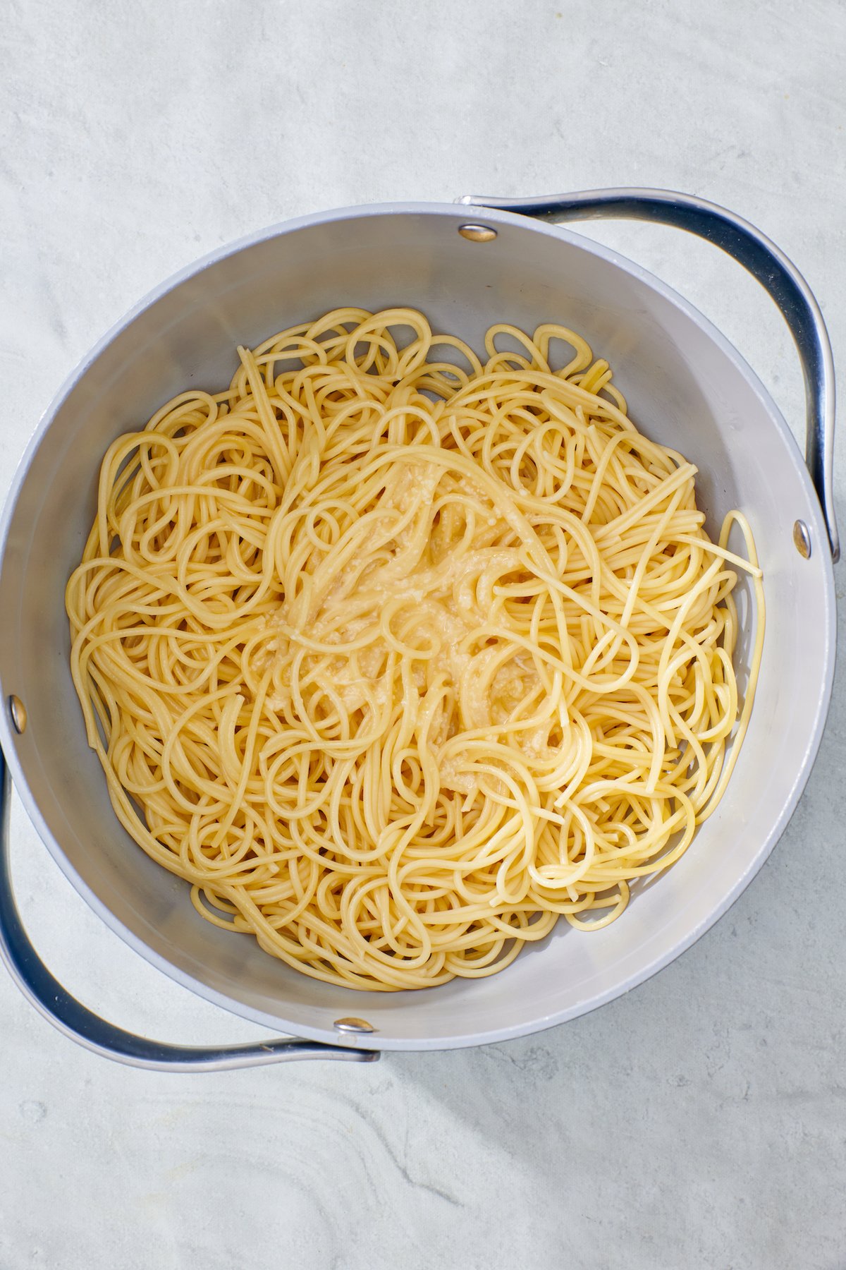 cooked spaghetti with egg/parmesan cheese mixture on top.