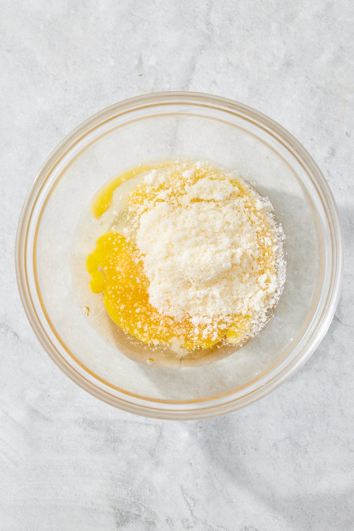 parmesan cheese and whisked eggs in a bowl.