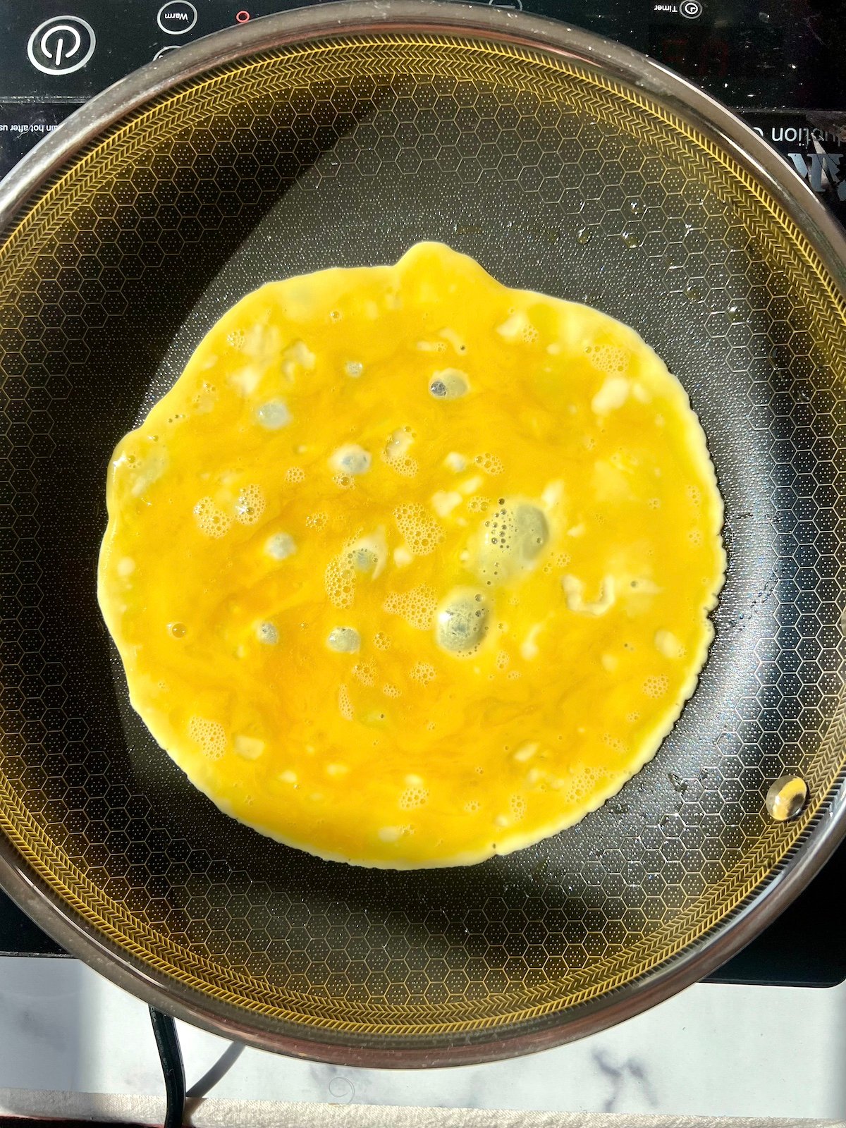 Thin omelette in skillet.