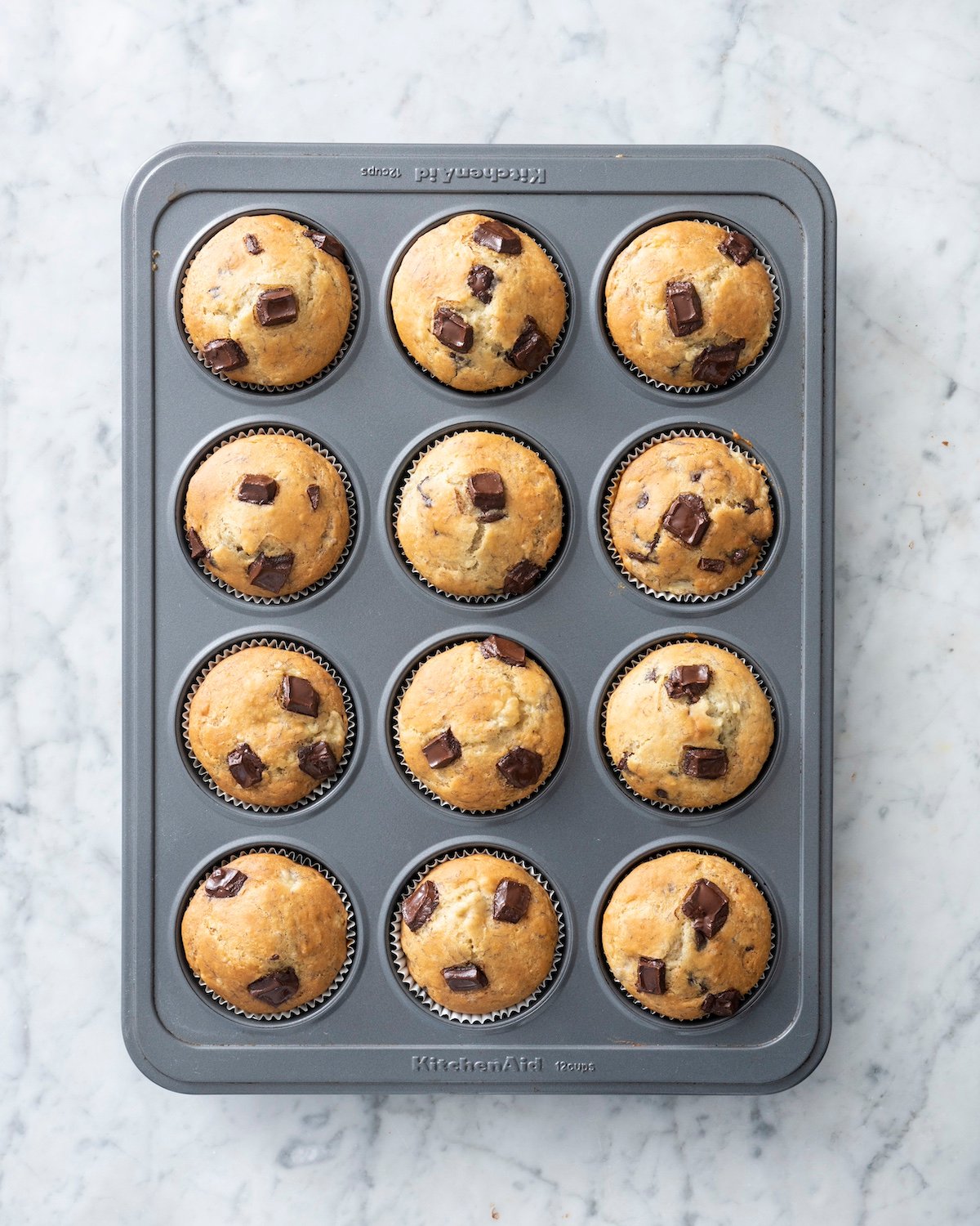 Banana chocolate chip muffins baked in muffin tin.