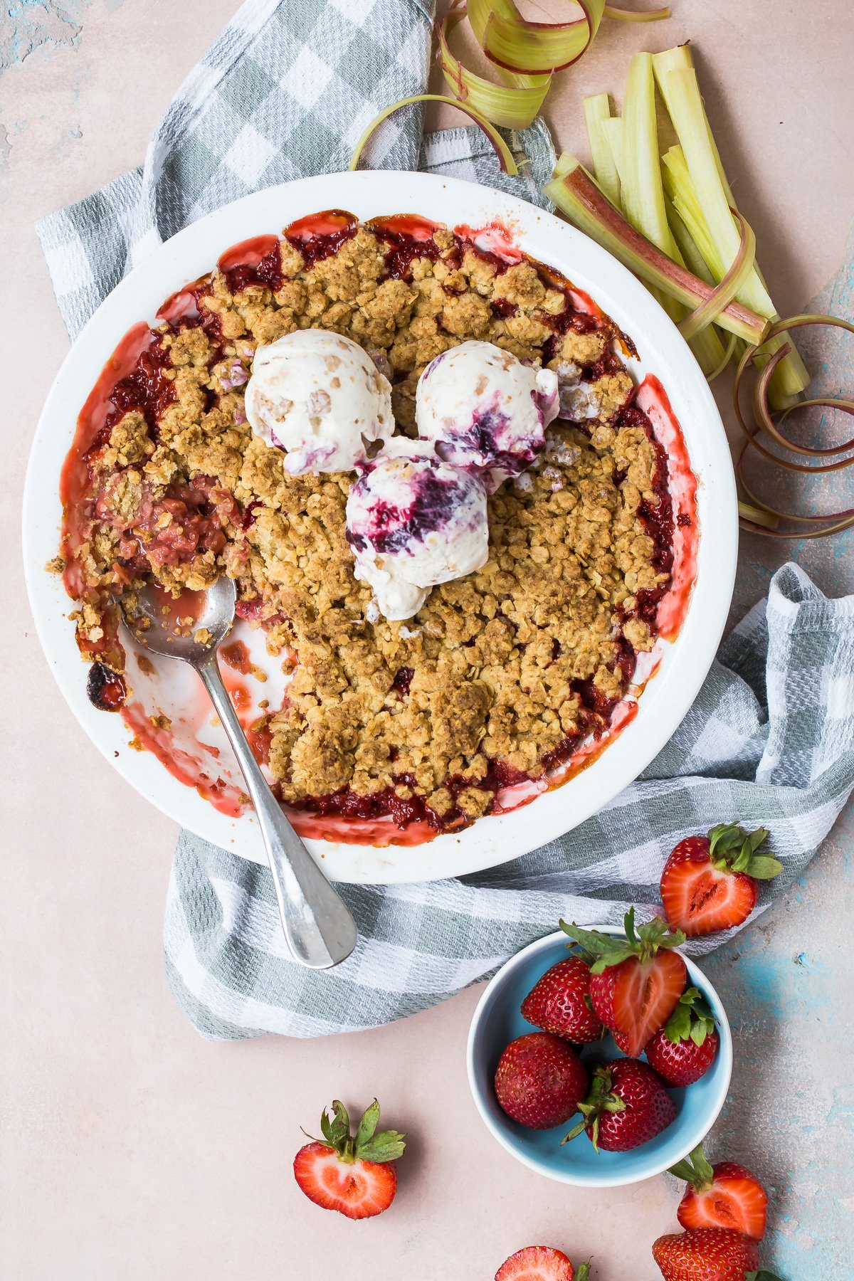 Strawberry rhubarb crumble topped with ice cream.
