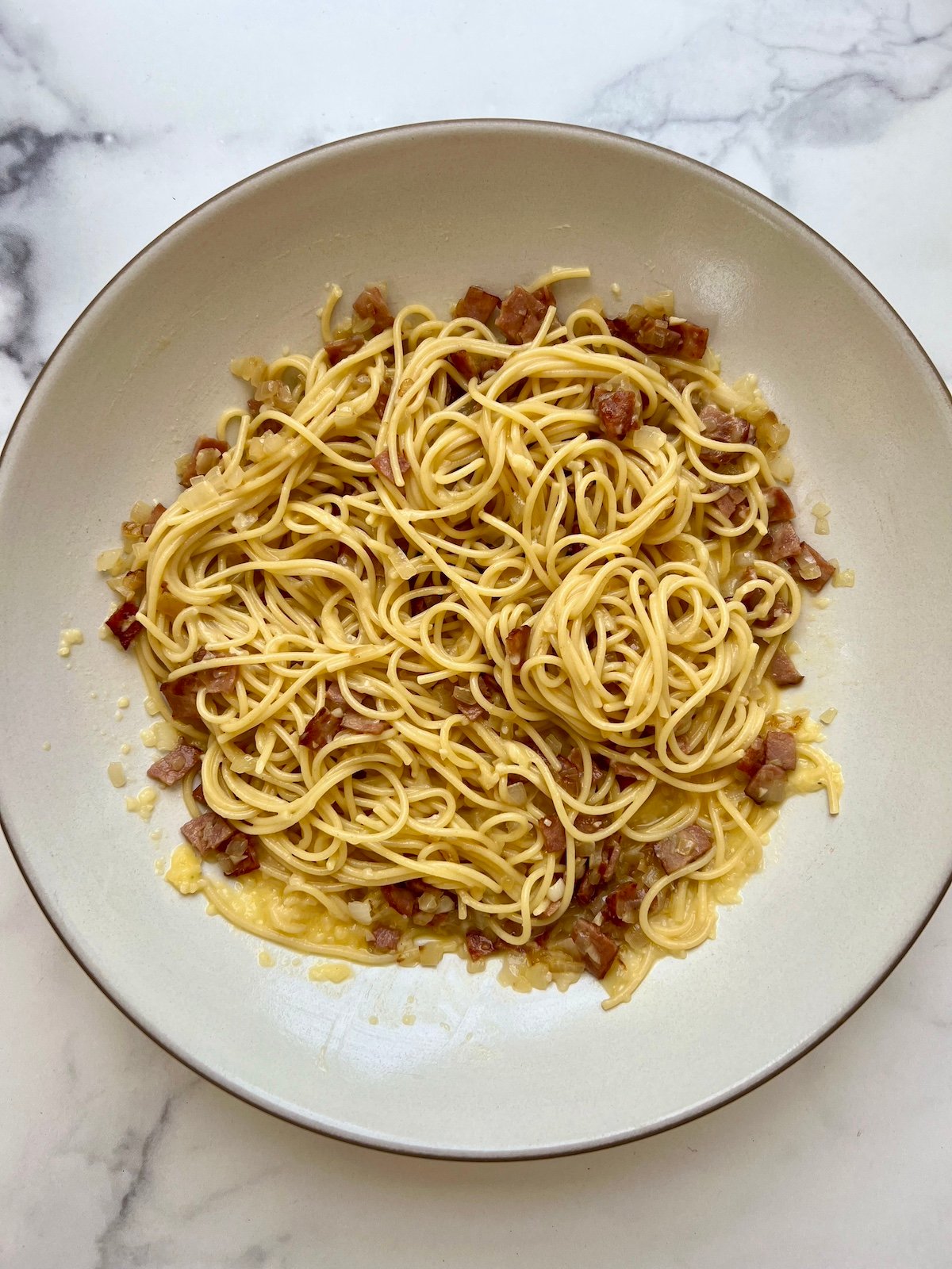 Lightened up spaghetti carbonara on serving platter.