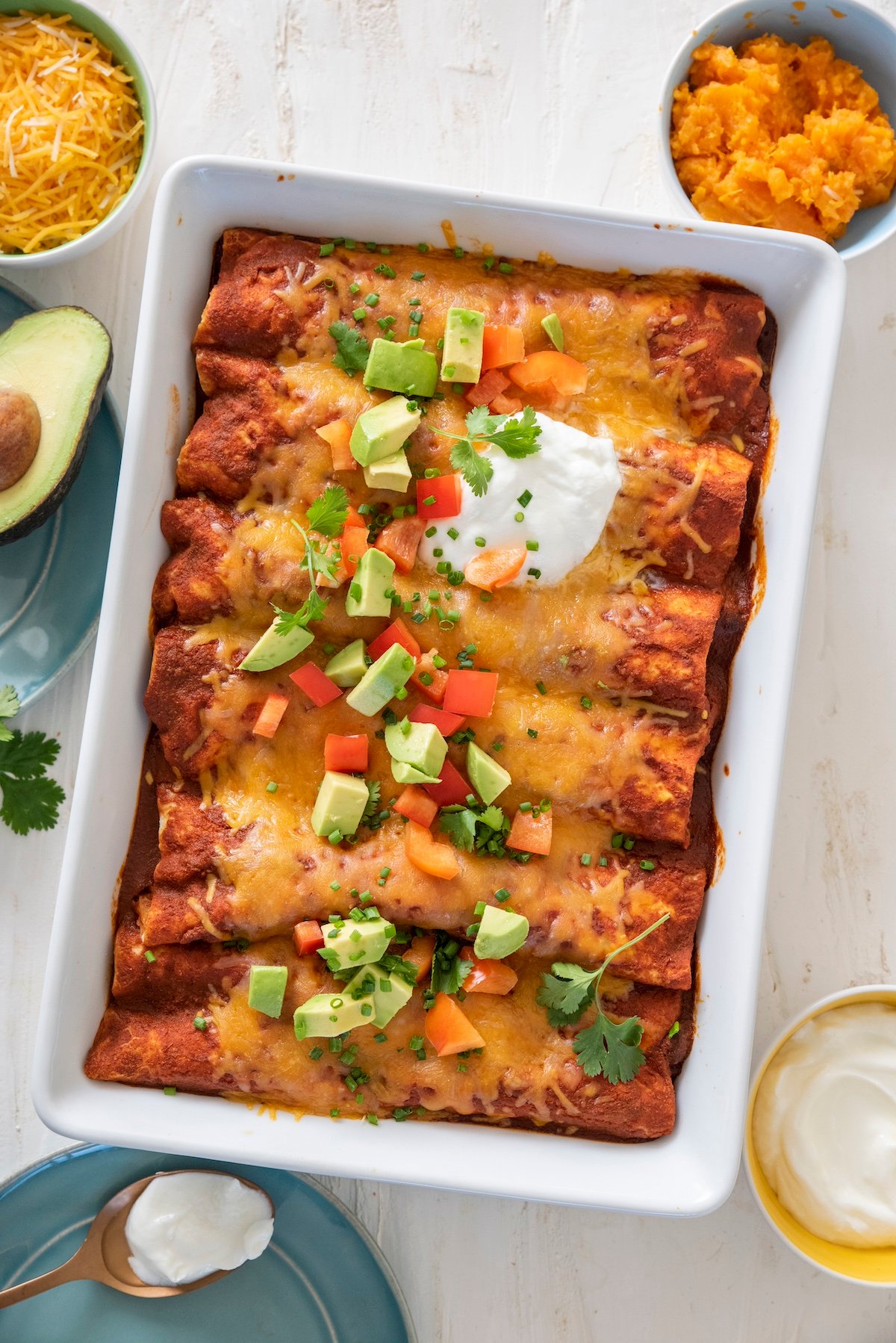 Sweet potato black bean enchiladas in a baking dish.