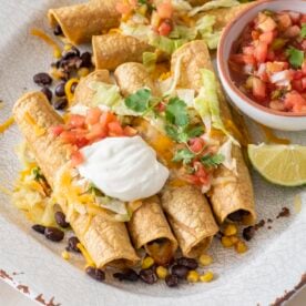 Vegetarian baked taquitos on a serving platter.