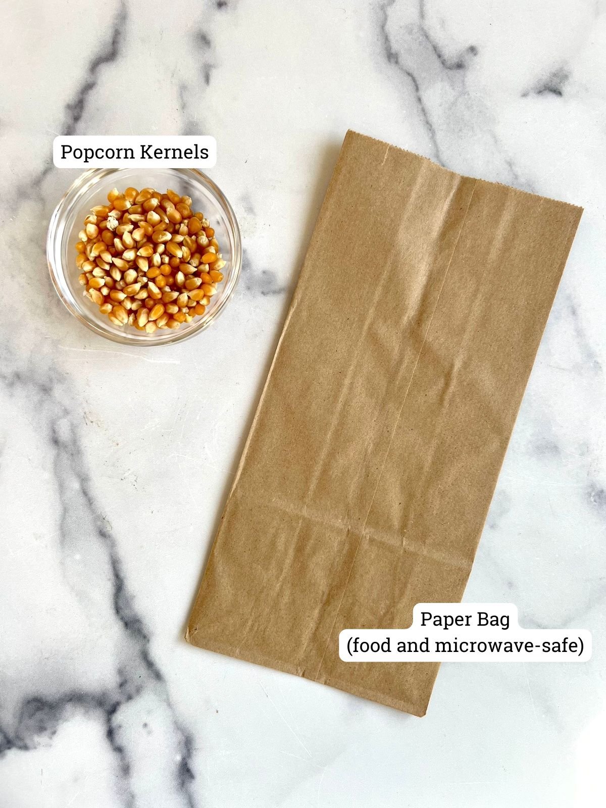 Popcorn kernels and a brown paper bag.