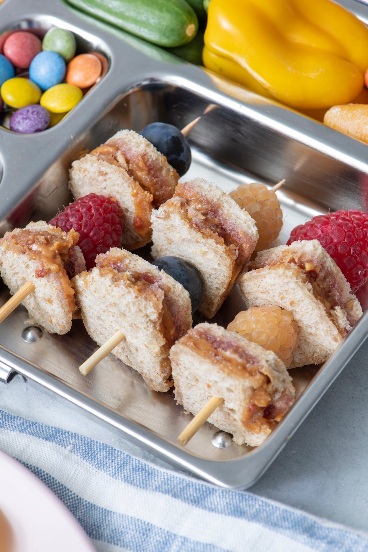 mini peanut butter and jelly skewers in a lunch box