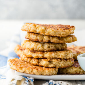 Crispy brown rice cakes cooling on a wire rack after pan frying