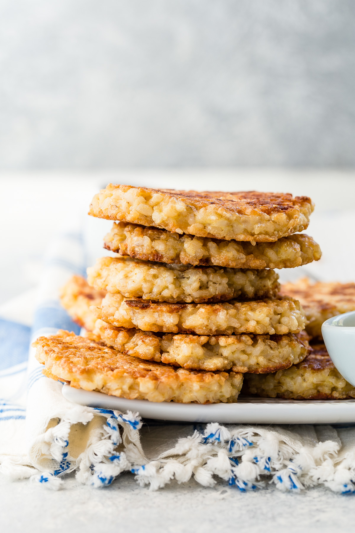 Crispy brown rice cakes cooling on a wire rack after pan frying