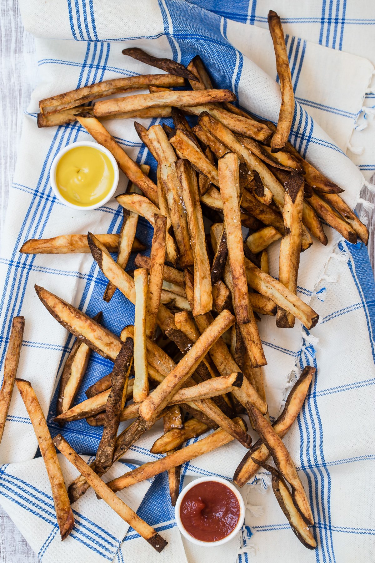 Air fryer french fries served with ketchup and honey mustard.