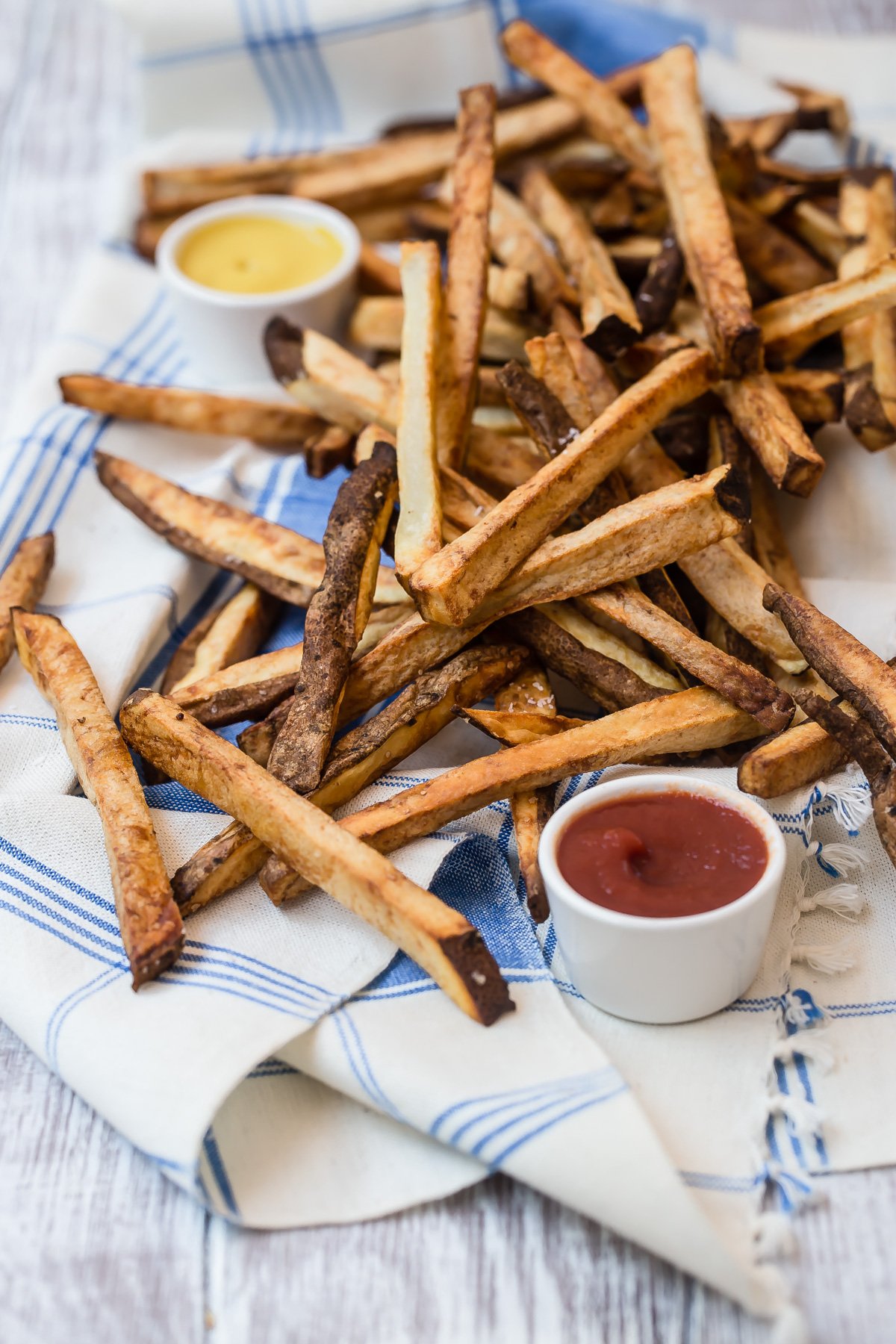 Air fryer french fries on tea towel.
