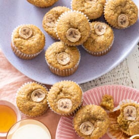 Banana Wheat Germ Muffins on pink and purple plates.