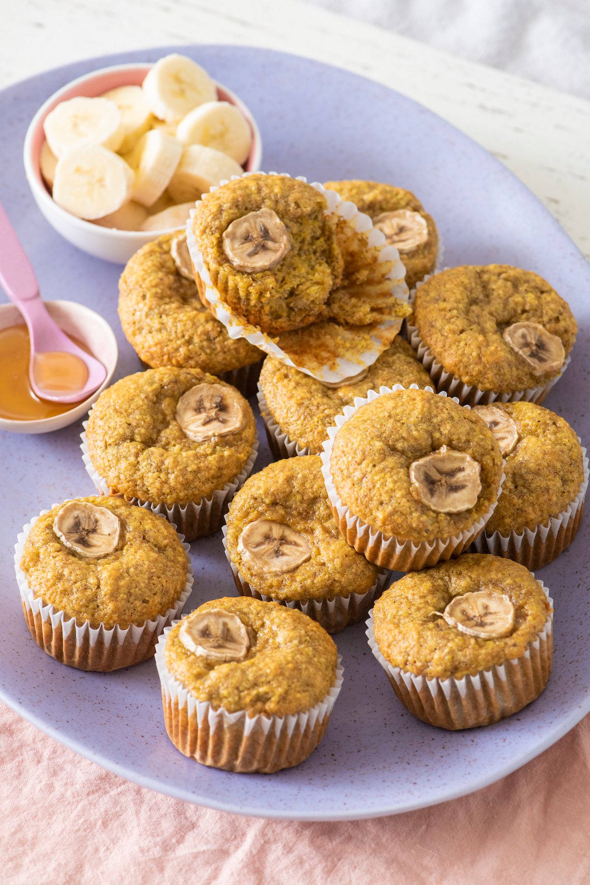 Banana Wheat Germ Muffins on pink and purple plates.