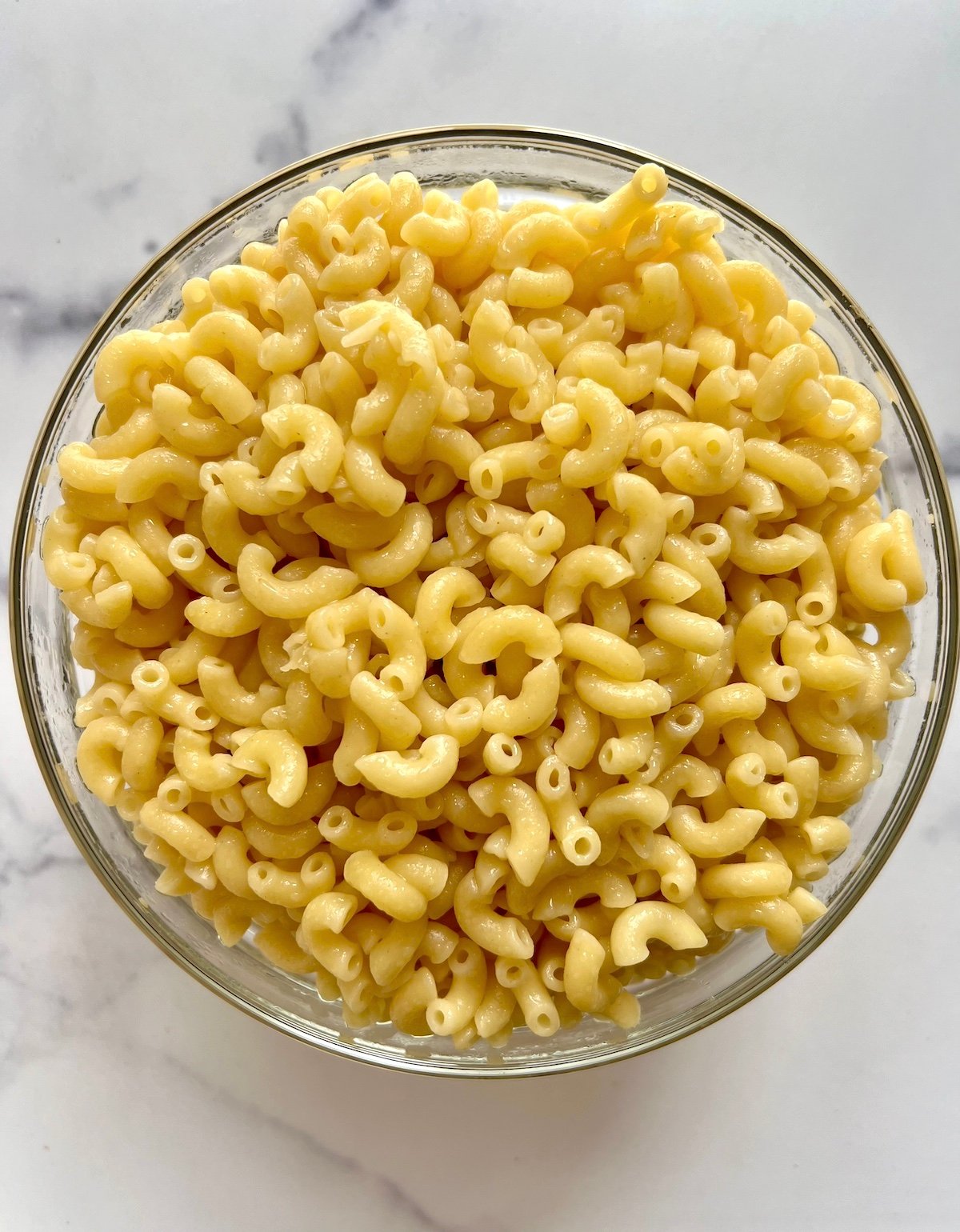 Boiled macaroni noodles in bowl.