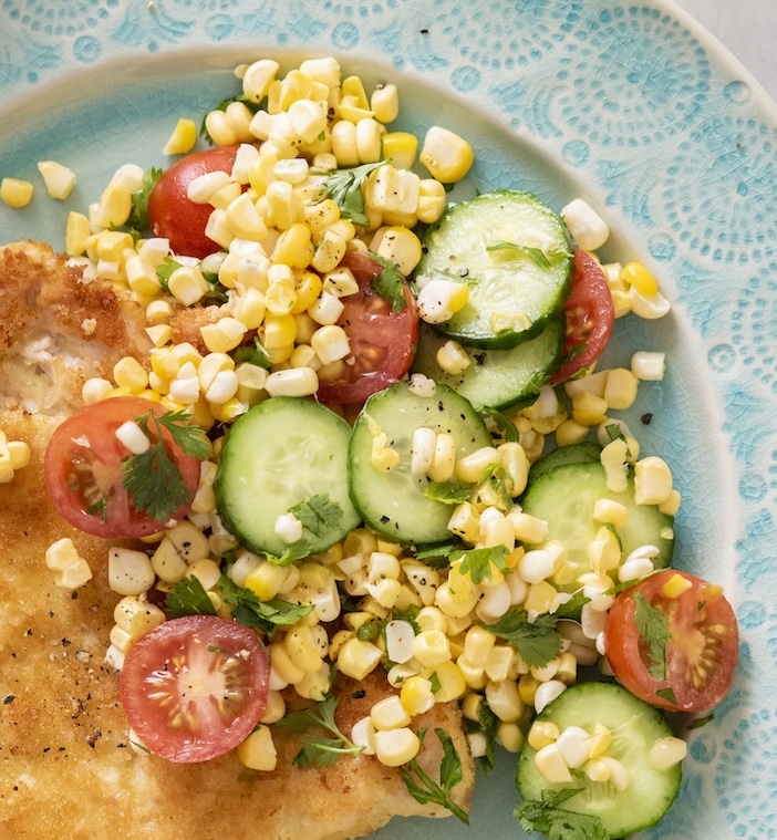 Summer salad with corn, cucumbers and tomatoes.