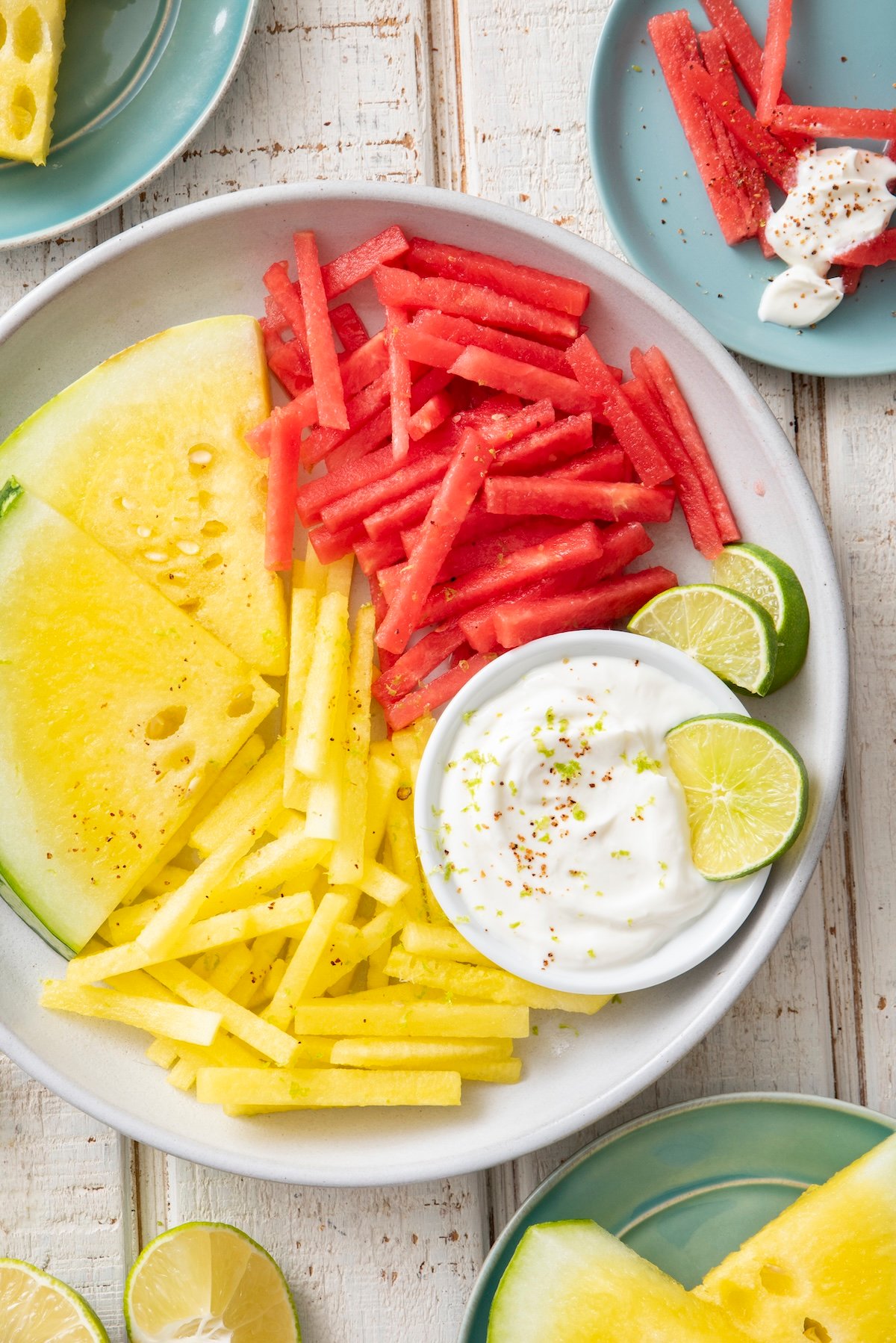 Yellow and red watermelon fries served with yogurt dip.