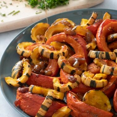 Pouring sweet and sour glaze over roasted squash.