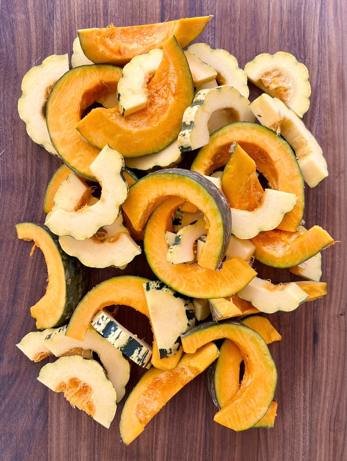 Cut delicata and kabocha squash ready for roasting.