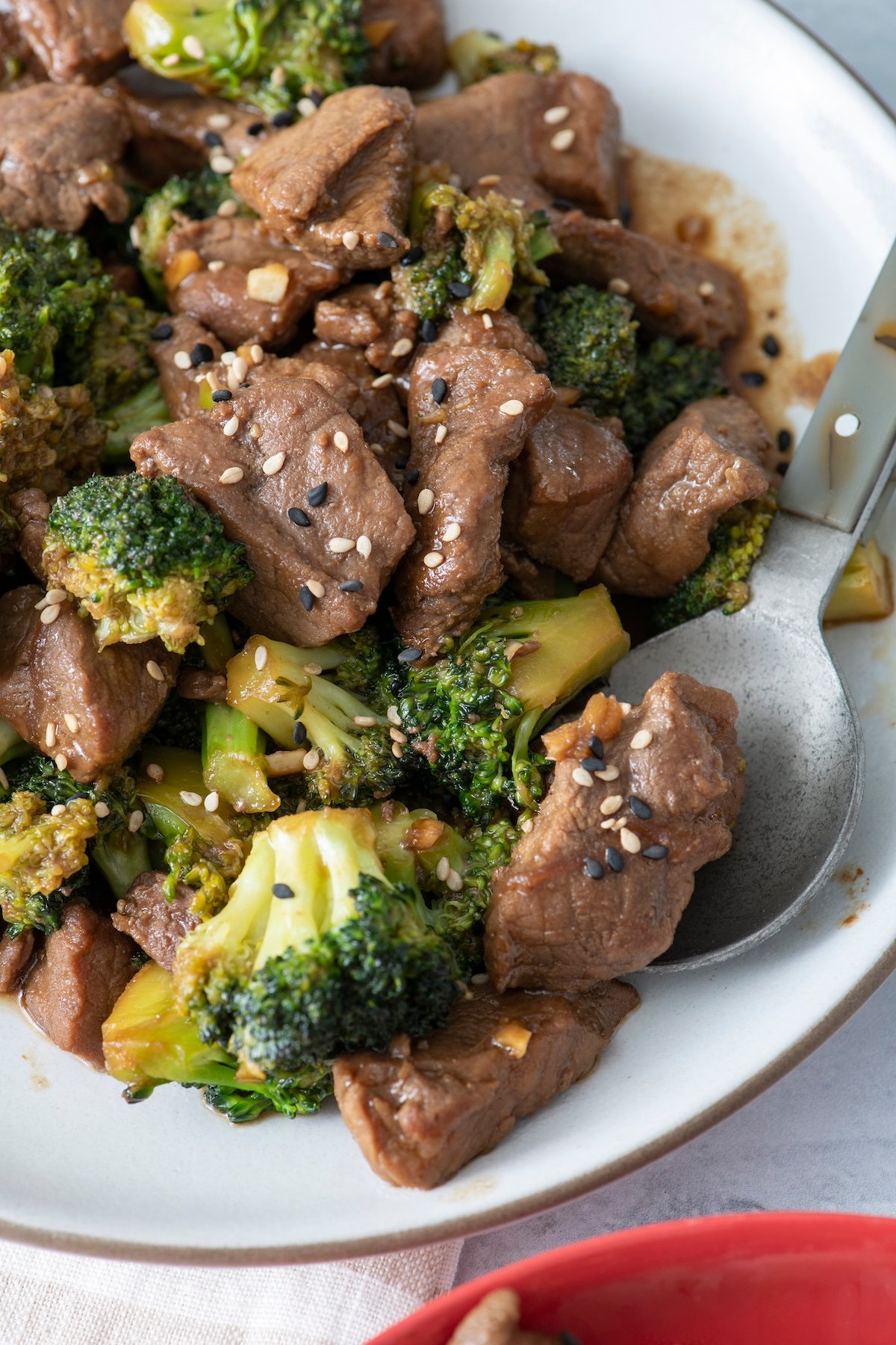 Beef and broccoli stir fry on white serving platter.