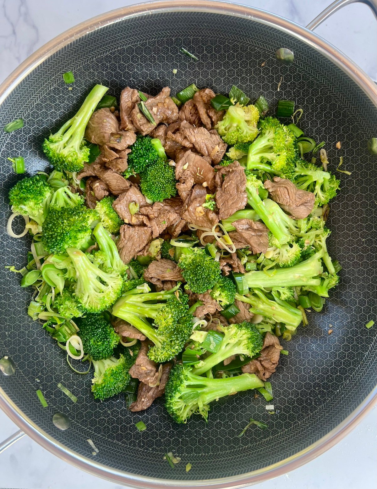 Beef and broccoli in sauté pan.