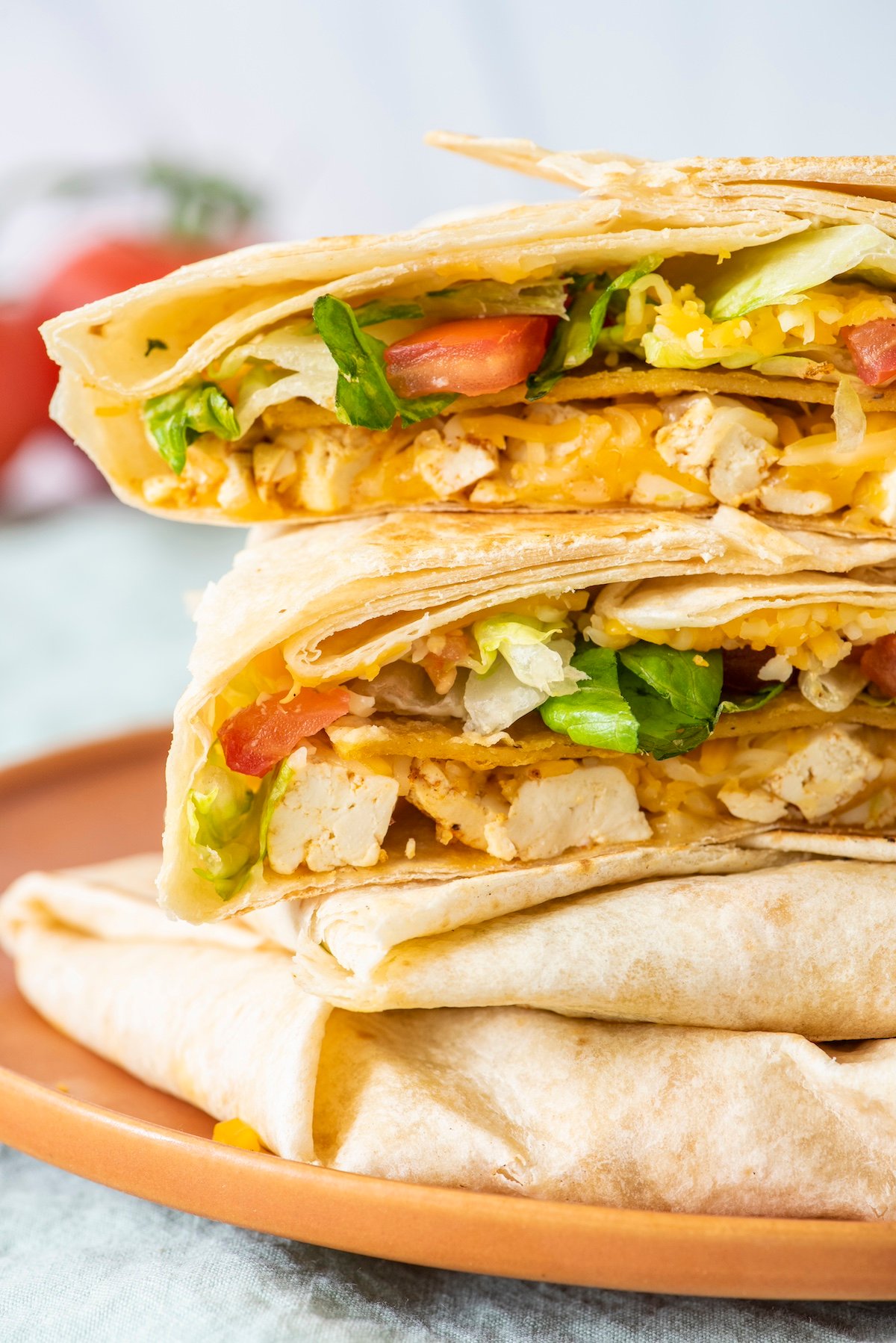 Stack of vegetarian crunchwrap supremes on a plate.