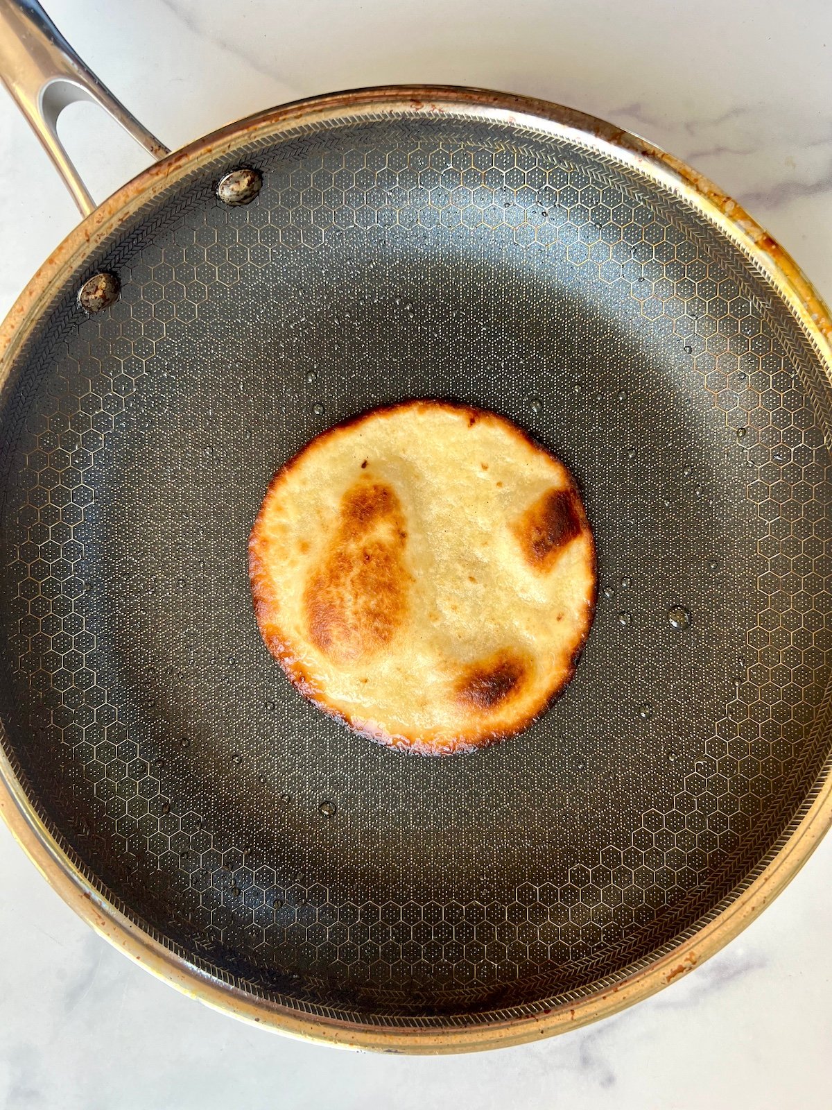 Small tortilla in sauté pan.