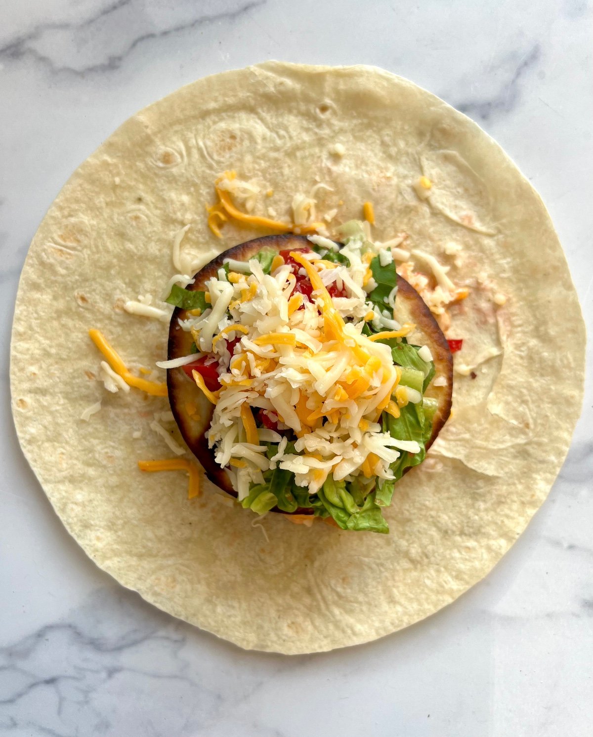 Unwrapped crunchwrap supreme on countertop.