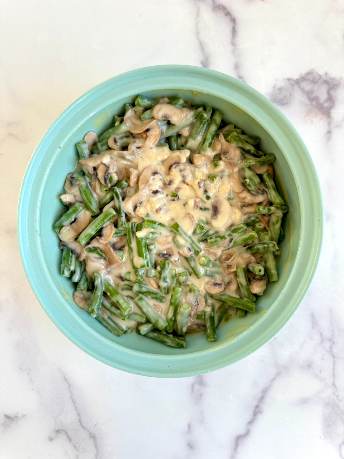 Green beans with mushroom sauce in a baking dish.