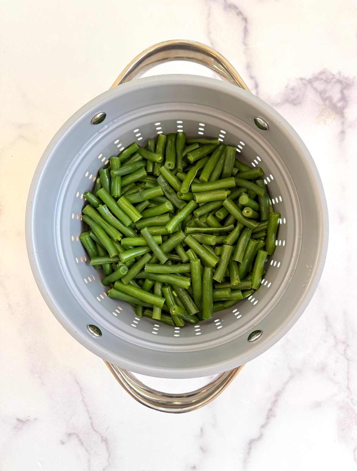 Green beans in a steamer pot.