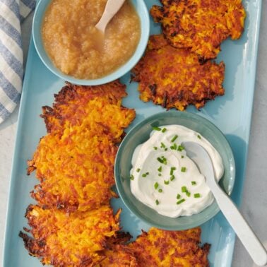 Carrot parsnip latkes served with applesauce and sour cream.