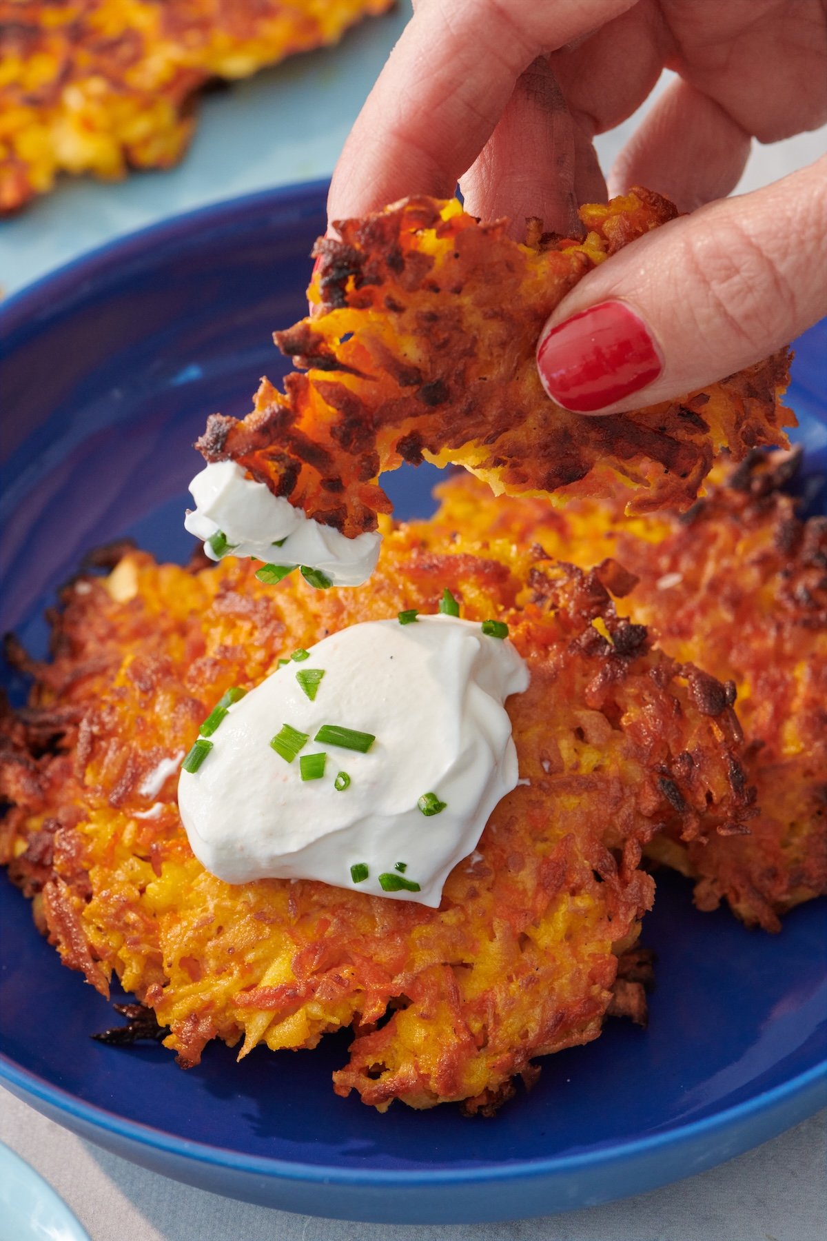Crispy carrot parsnip latkes on a plate.
