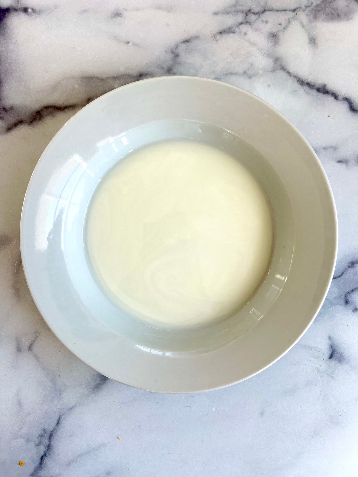 Buttermilk in a shallow bowl.