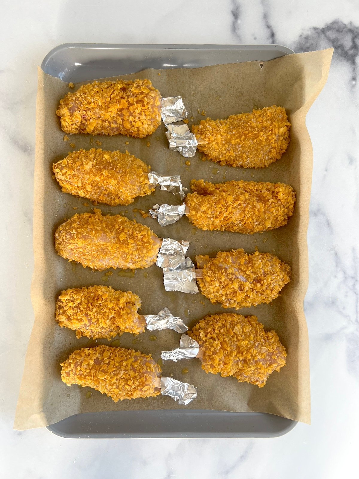 Chicken on a sticks on a sheet tray.