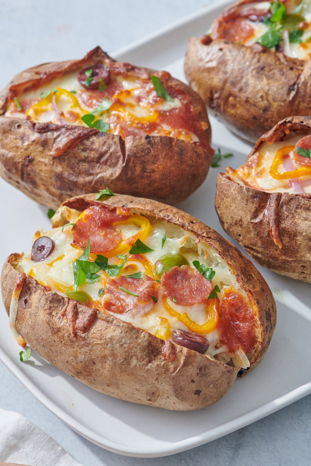 olives, pepperoni, cheese and yellow pepper baked potatoe