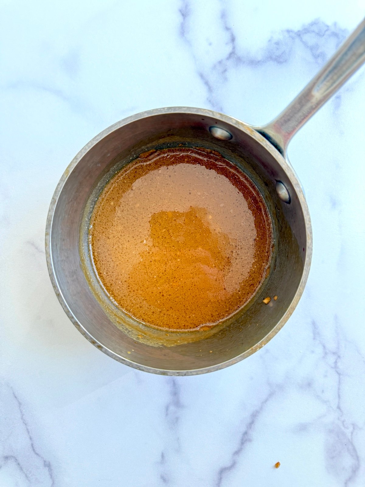 Marinade reducing in a sauce pan.