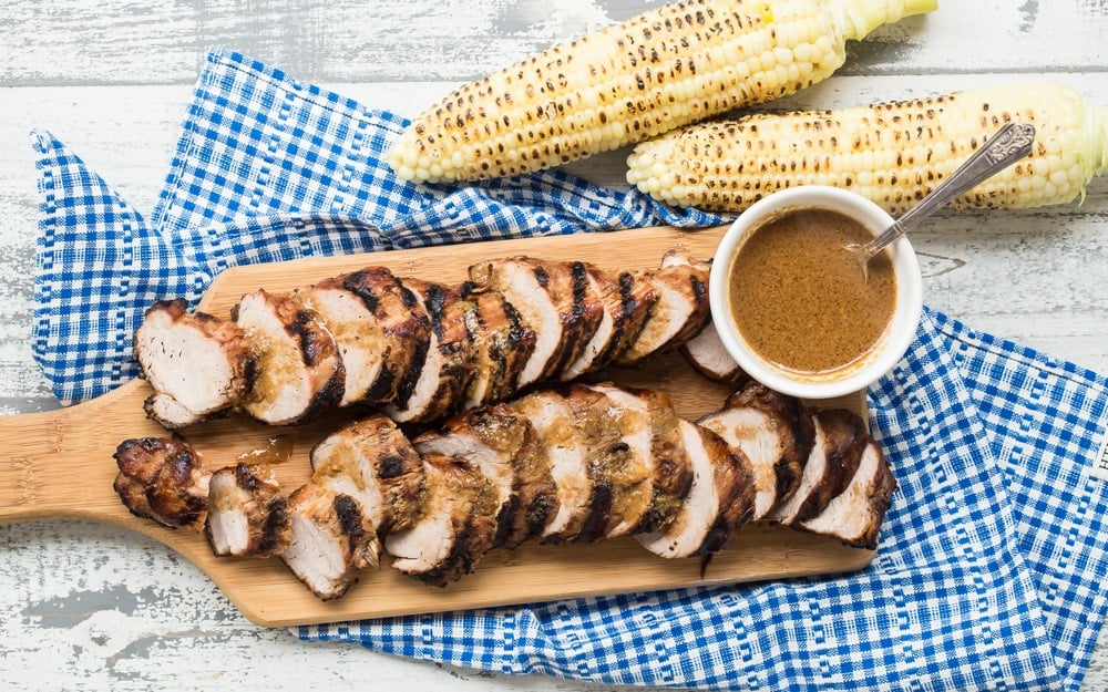 souther style pork tenderloin on serving board with glaze