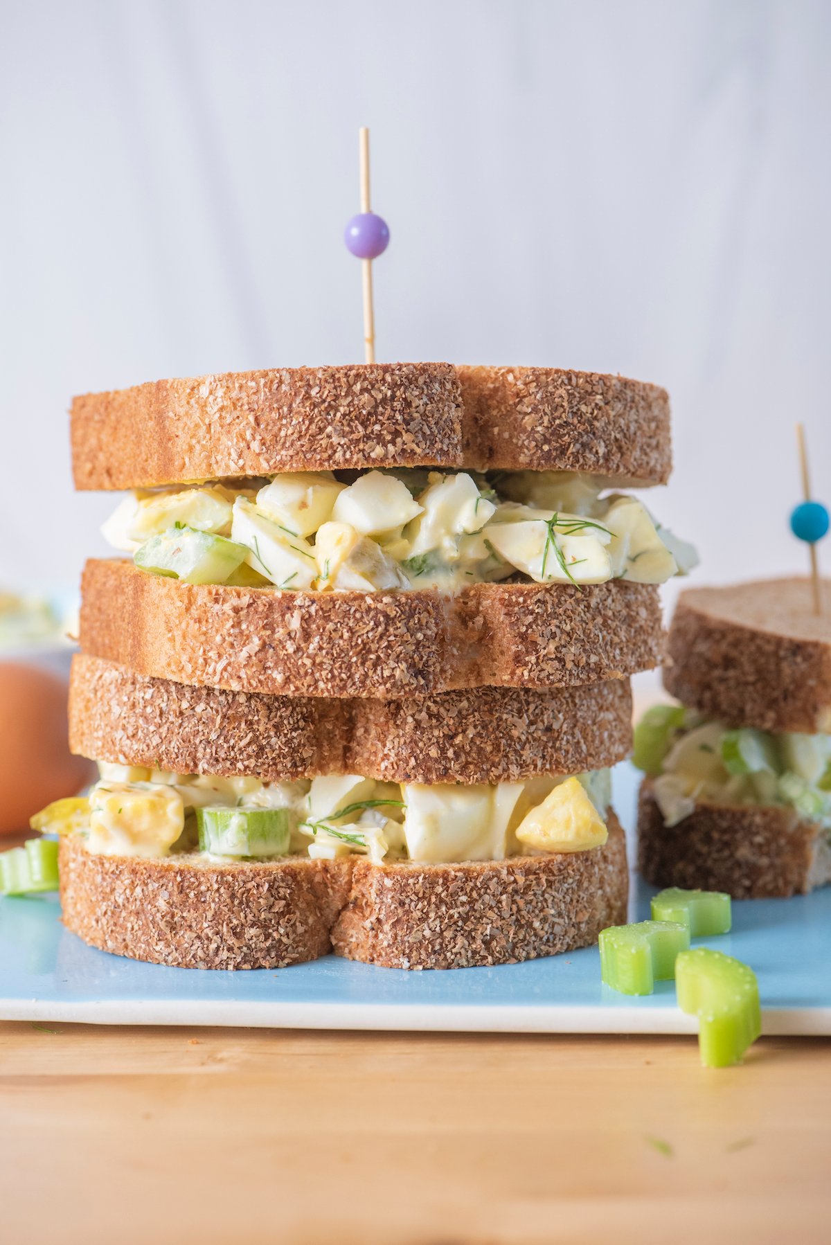 Stack of two egg salad sandwiches on top of each other.