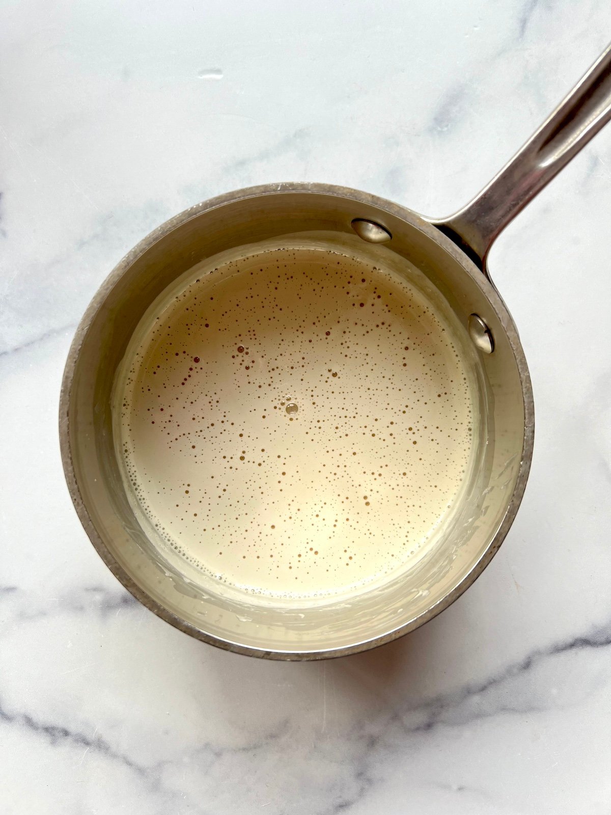 Homemade coffee creamer in saucepan.