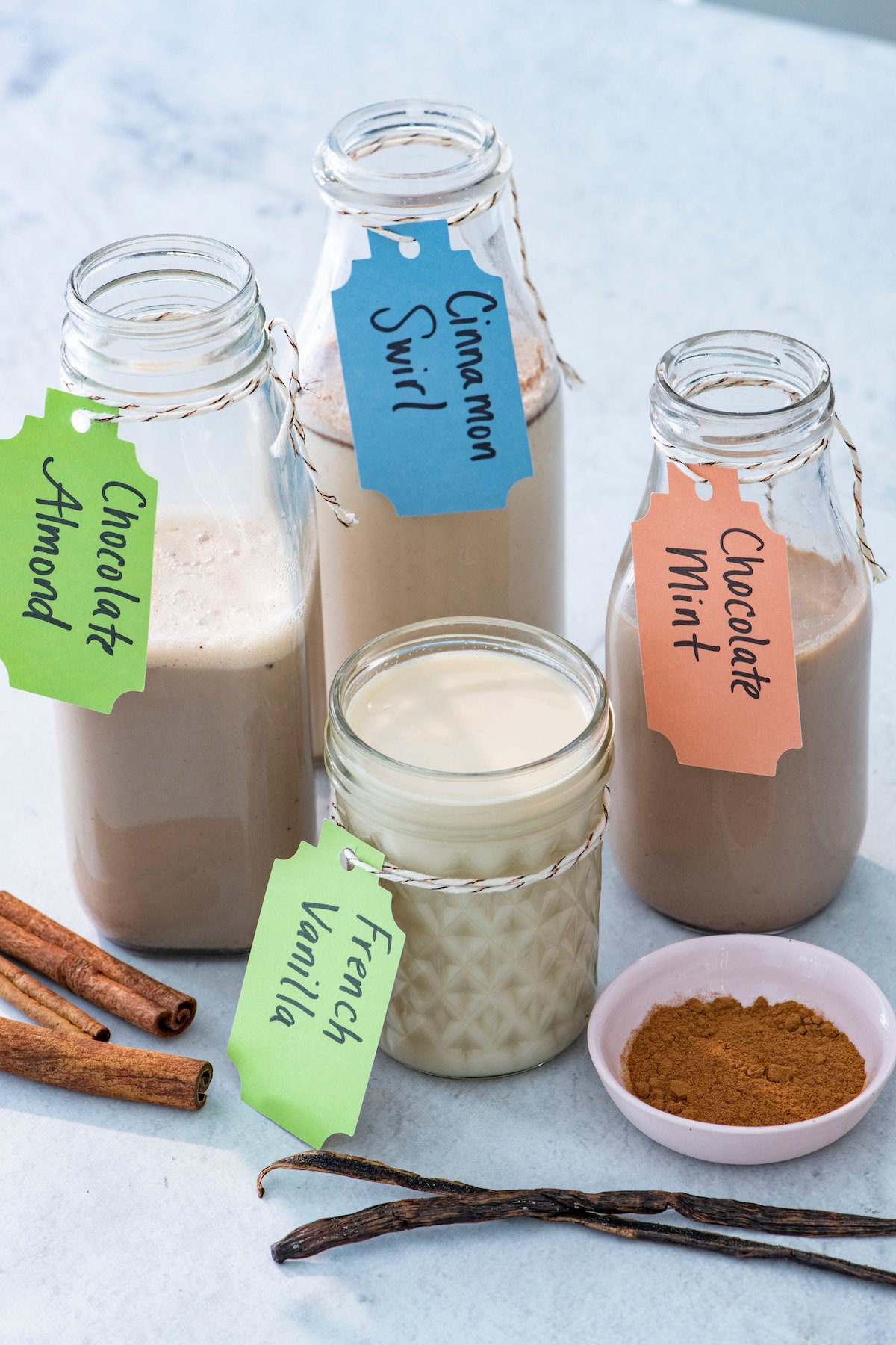 Homemade coffee creamer in glass containers.