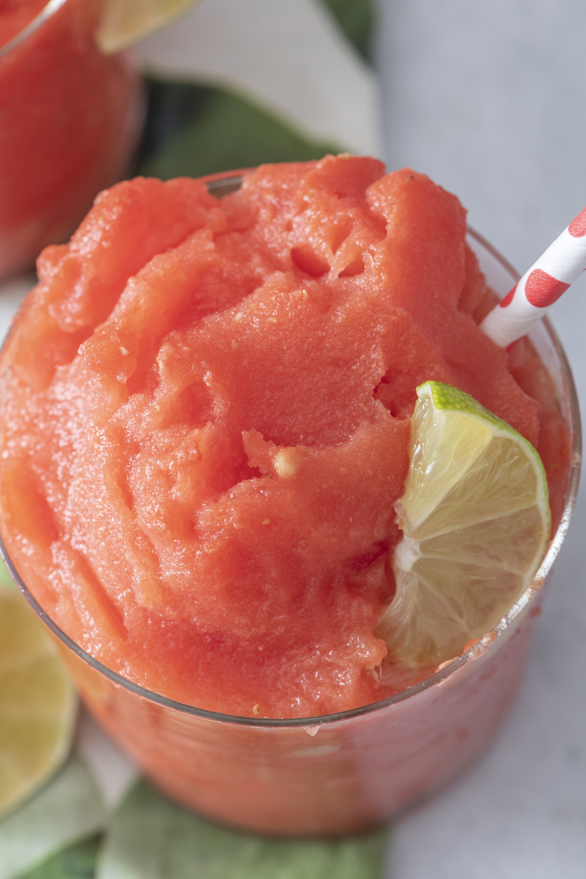 Watermelon slushie with lime wedge.