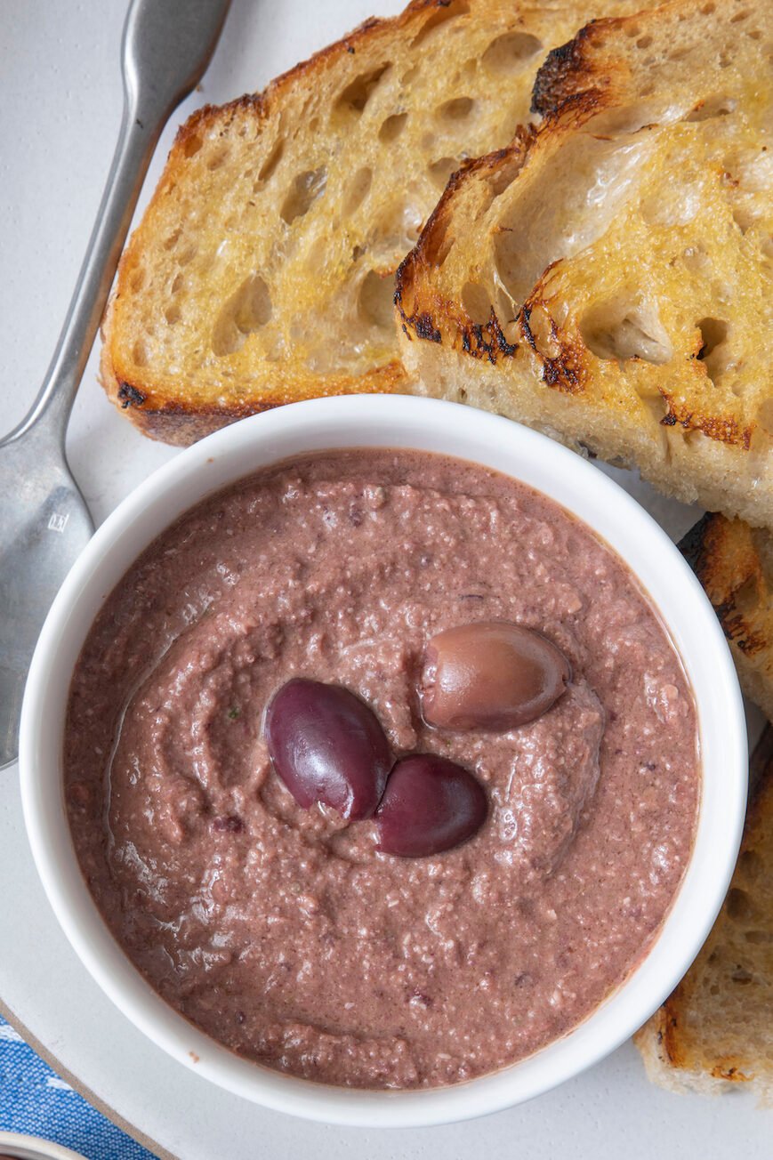 Close up of olive tapenade in serving bowl. 