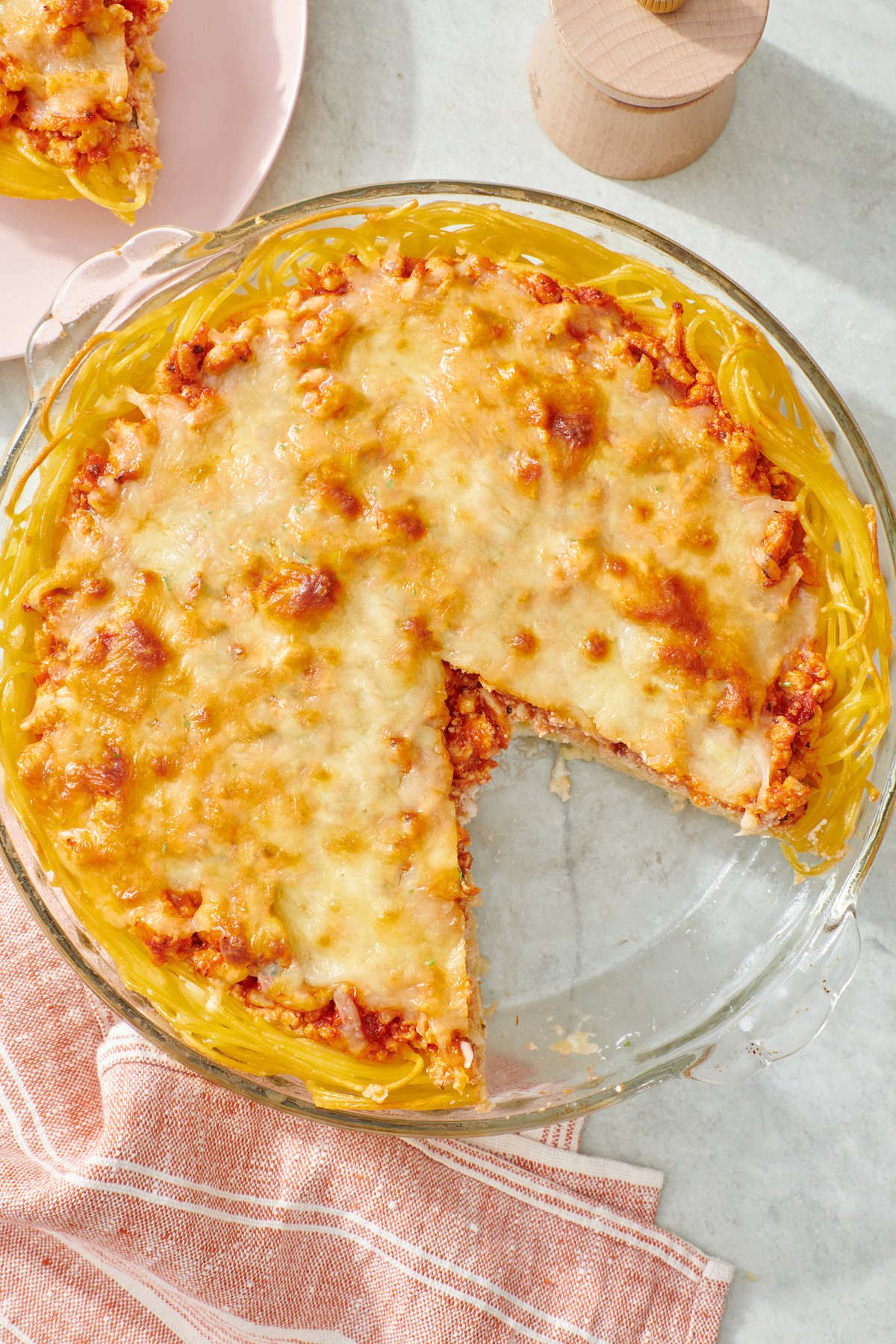 Spaghetti pie with slice removed.