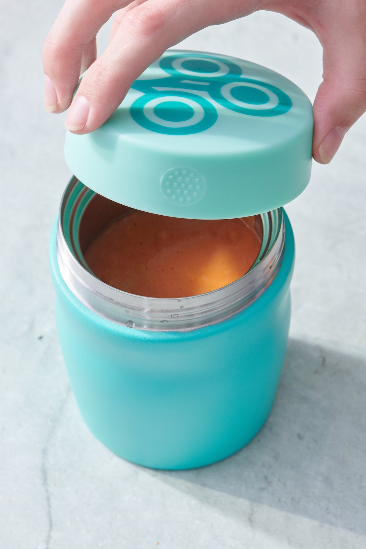 Placing the lid onto a thermos.