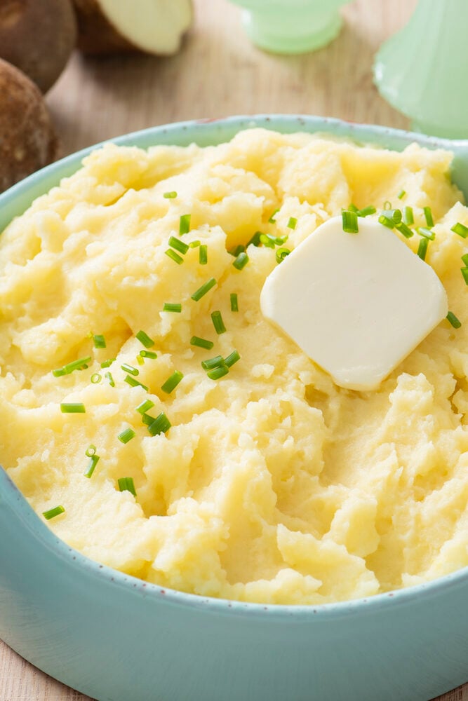 Pat of butter and chives on mashed potatoes.